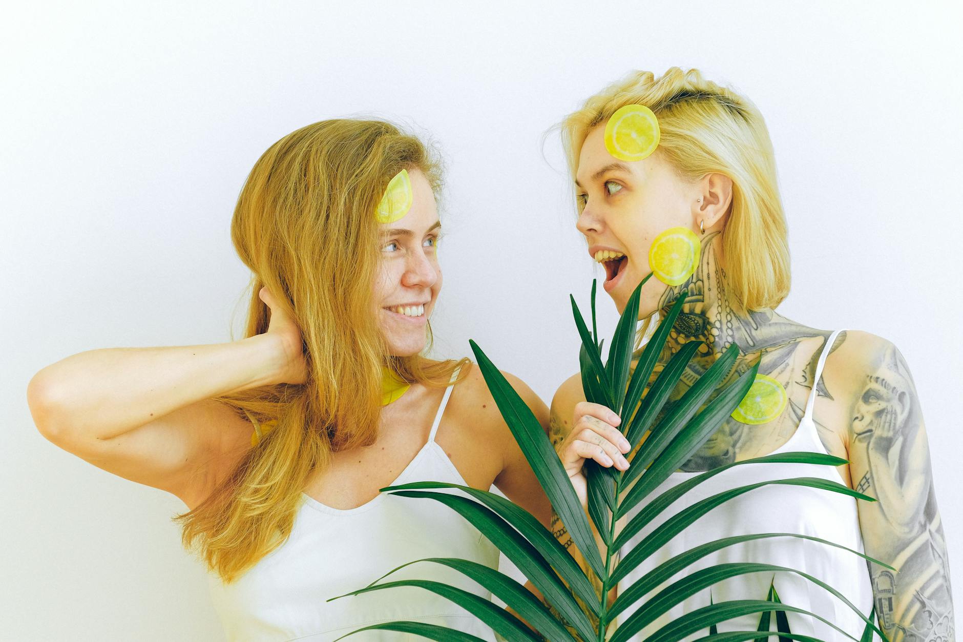 Two women smiling together during a joyful moment, representing connection and intimacy