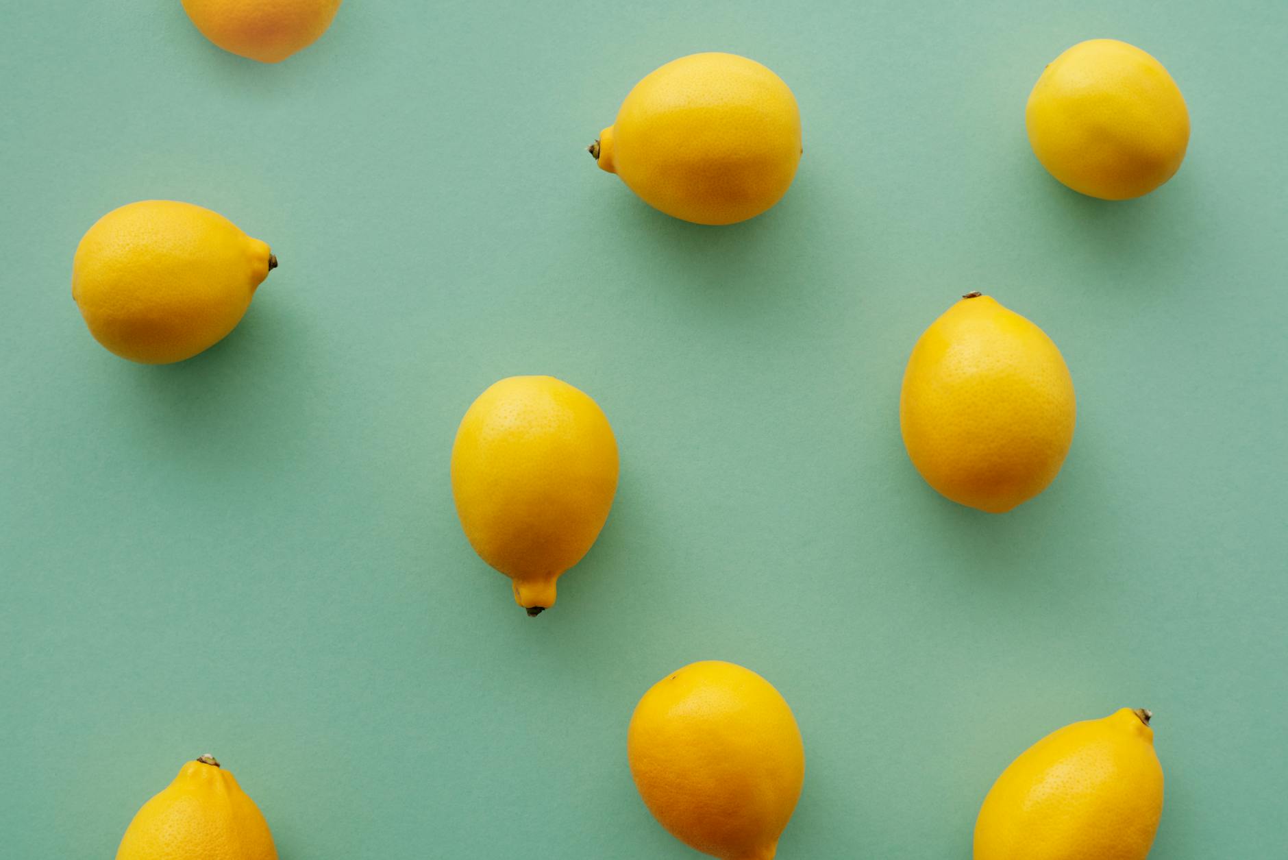 Fresh yellow lemons arranged on a vibrant background showcasing natural citrus brightness