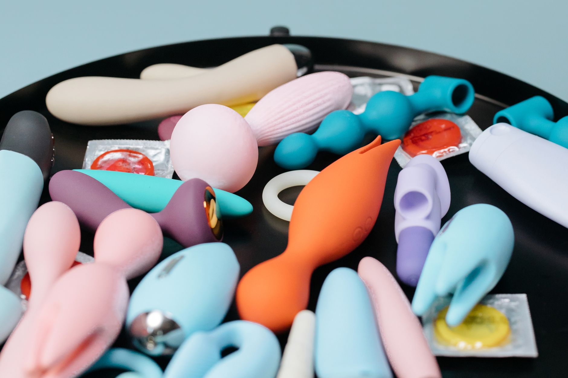 A blue silicone lemon vibrator held in hand, representing accessible pleasure for beginners