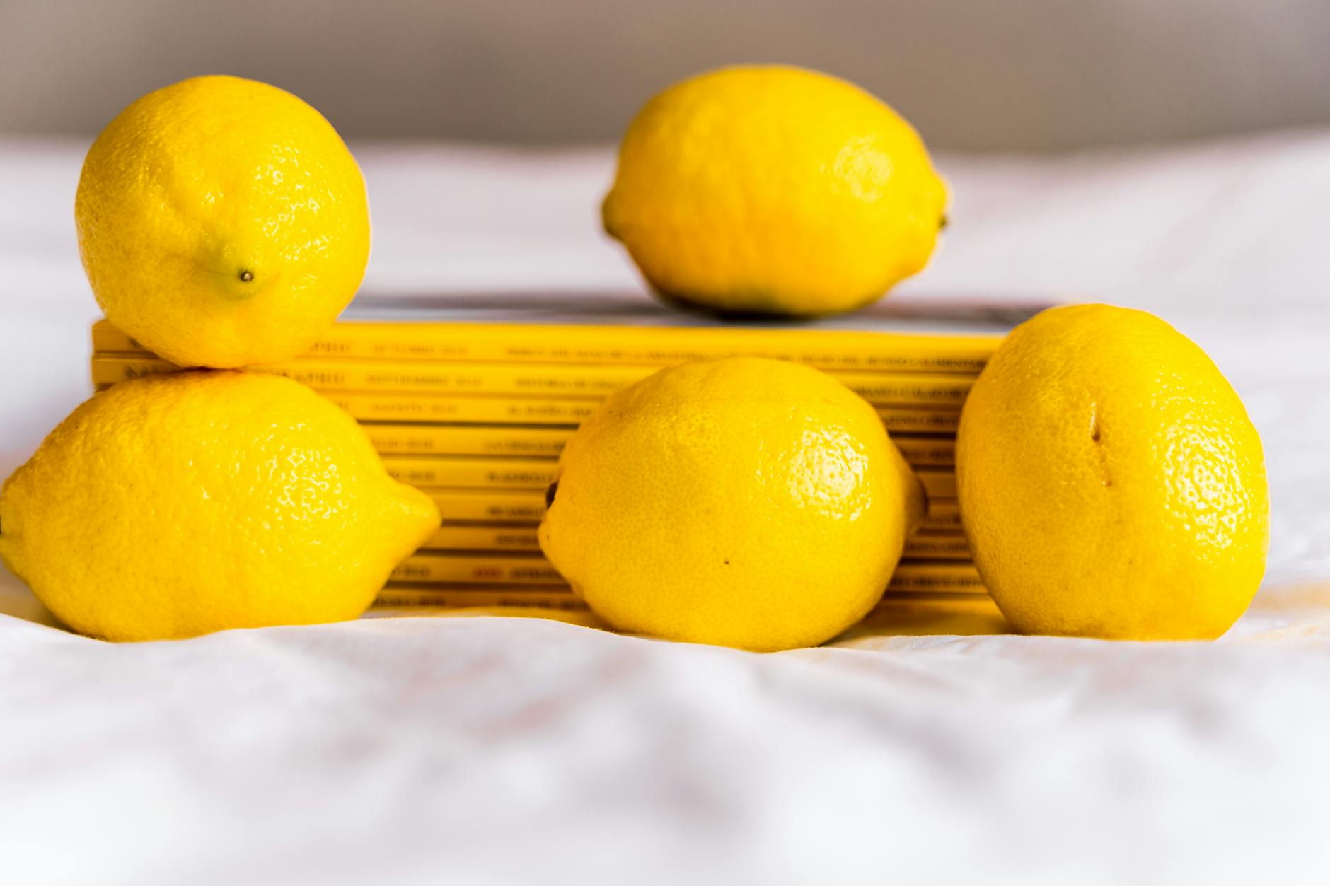 A vibrator surrounded by fresh flowers and citrus slices on a bright yellow background